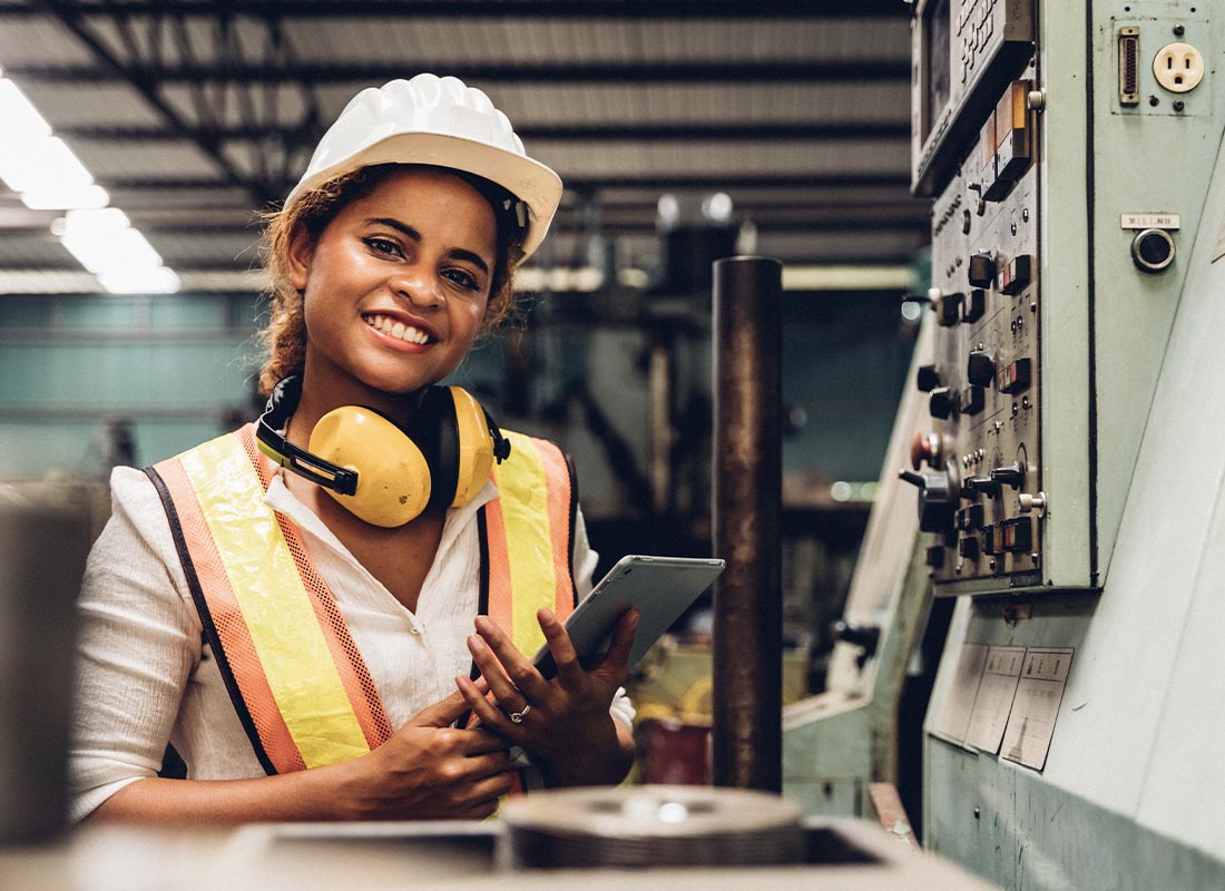 Insurance by Industry - Industry Maintenance Engineer Woman Wearing Uniform and Safety Helmet Under Inspection and Checking Production Process by Tablet
